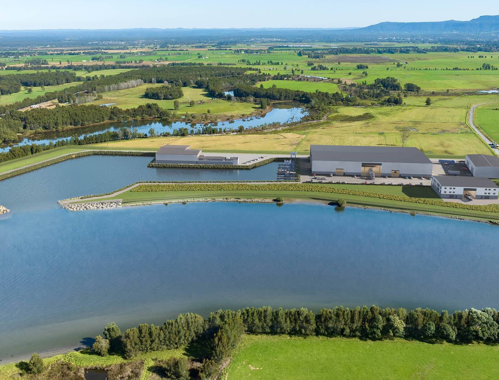 Aerial view of the ECMC basin, waterfront land and surrounding Shoalhaven landscape